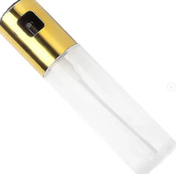 Glasflaska med en olivolja spruta och ett guldlock
